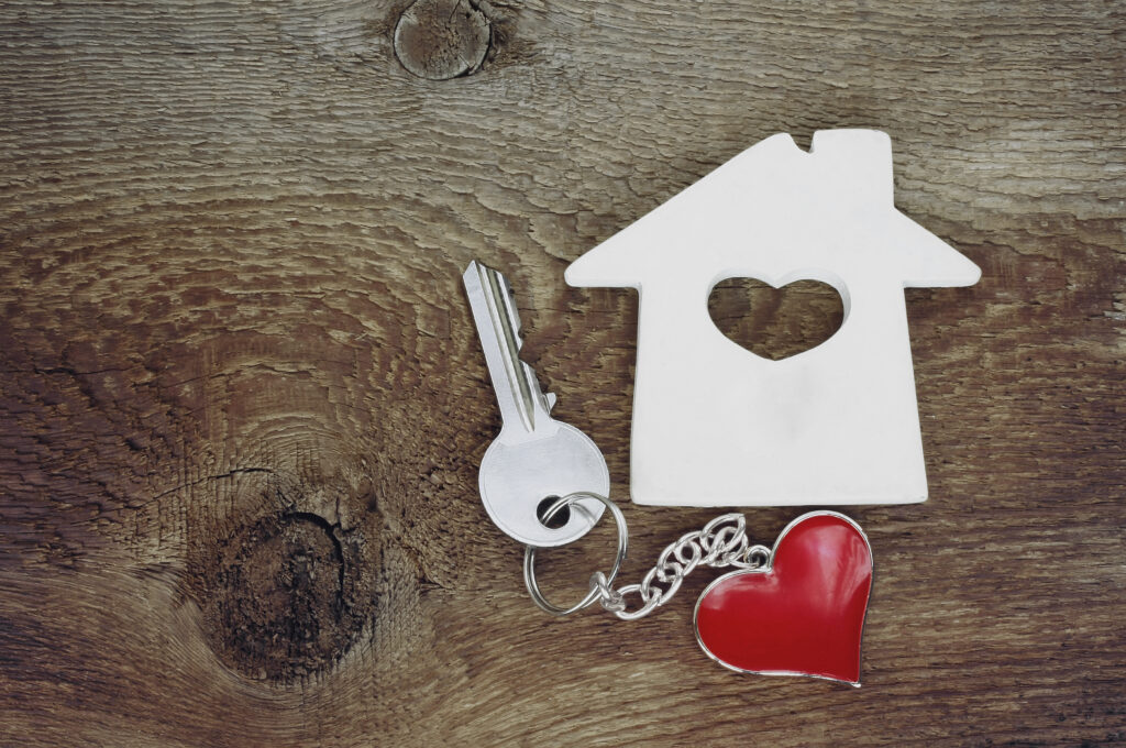 small house and a key with a keychain in shape of heart